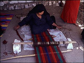 settled nomad weaving a piece