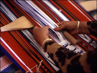 sword beater in use on loom